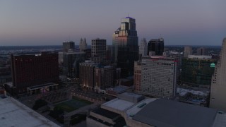 DX0001_001381 - 5.7K aerial stock footage of flying by tall city skyscrapers at twilight in Downtown Kansas City, Missouri