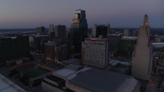DX0001_001386 - 5.7K aerial stock footage of flying by skyscrapers and office buildings at twilight in Downtown Kansas City, Missouri