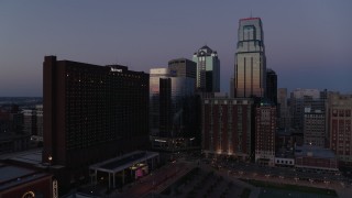 DX0001_001387 - 5.7K aerial stock footage of flying by and away from hotel and skyscrapers at twilight in Downtown Kansas City, Missouri