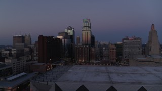 DX0001_001388 - 5.7K aerial stock footage of downtown hotel and skyscrapers at twilight in Downtown Kansas City, Missouri