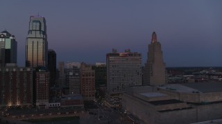 DX0001_001390 - 5.7K aerial stock footage of a downtown hotel and skyscrapers at twilight in Downtown Kansas City, Missouri