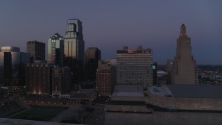 DX0001_001391 - 5.7K aerial stock footage flyby a downtown hotel and skyscrapers at twilight in Downtown Kansas City, Missouri
