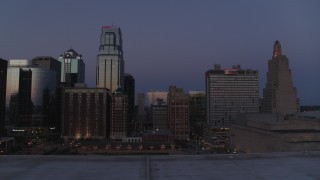 DX0001_001393 - 5.7K aerial stock footage ascend with a view of a hotel and skyscrapers at twilight in Downtown Kansas City, Missouri