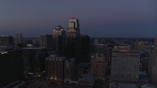 DX0001_001394 - 5.7K aerial stock footage descend with a view of skyscrapers at twilight in Downtown Kansas City, Missouri