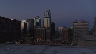 DX0001_001395 - 5.7K aerial stock footage of skyscrapers between hotels and city buildings at twilight in Downtown Kansas City, Missouri