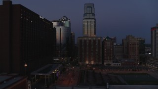 DX0001_001396 - 5.7K aerial stock footage of skyscrapers between hotels and office buildings at twilight in Downtown Kansas City, Missouri