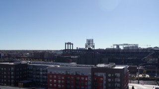 DX0001_001488 - 5.7K aerial stock footage ascend by apartment buildings to reveal Coors Field baseball stadium, Downtown Denver, Colorado