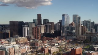 DX0001_001525 - 5.7K aerial stock footage of flying past towering skyscrapers of the city skyline in Downtown Denver, Colorado