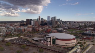DX0001_001534 - 5.7K aerial stock footage of the city skyline seen from while flying by arena, Downtown Denver, Colorado