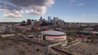 DX0001_001535 - 5.7K aerial stock footage of descending near the arena with the city skyline in the background, Downtown Denver, Colorado