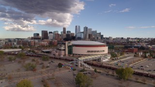DX0001_001536 - 5.7K aerial stock footage of the Pepsi Center arena with the city skyline in the background, Downtown Denver, Colorado