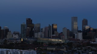 DX0001_001589 - 5.7K aerial stock footage of flying by the city's downtown skyscrapers by convention center at twilight, Downtown Denver, Colorado