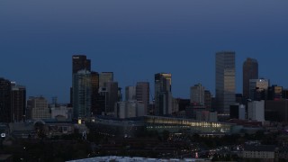 DX0001_001590 - 5.7K aerial stock footage of passing by the city's downtown skyscrapers and convention center at twilight, Downtown Denver, Colorado