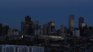 DX0001_001593 - 5.7K aerial stock footage of the city's skyscrapers by convention center at twilight, then descend, Downtown Denver, Colorado