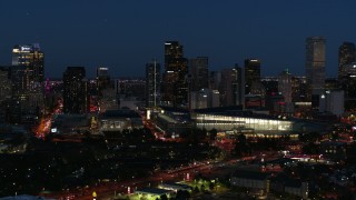 DX0001_001607 - 5.7K aerial stock footage of the city skyline behind the convention center at twilight, Downtown Denver, Colorado