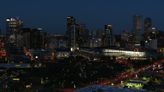 DX0001_001608 - 5.7K aerial stock footage of the city skyline behind the convention center at twilight, Downtown Denver, Colorado