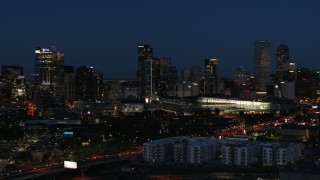 DX0001_001609 - 5.7K aerial stock footage reverse view of the city skyline behind the convention center at twilight, Downtown Denver, Colorado