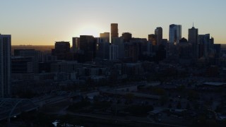 DX0001_001612 - 5.7K aerial stock footage of the city skyline at sunrise, reveal residential skyscraper in Downtown Denver, Colorado