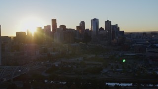 DX0001_001617 - 5.7K aerial stock footage flyby skyscraper for view of city skyline at sunrise in Downtown Denver, Colorado