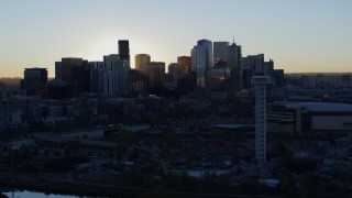 DX0001_001618 - 5.7K aerial stock footage flyby rising sun and city skyline at sunrise in Downtown Denver, Colorado