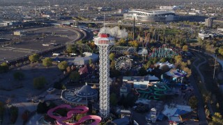 DX0001_001636 - 5.7K aerial stock footage of flying by rides at Elitch Gardens at sunrise in Downtown Denver, Colorado