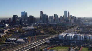 DX0001_001639 - 5.7K aerial stock footage flying by the city skyline at sunrise in Downtown Denver, Colorado
