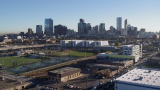 DX0001_001643 - 5.7K aerial stock footage reverse view of the city skyline at sunrise, seen during descent in Downtown Denver, Colorado