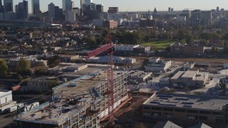 DX0001_001651 - 5.7K aerial stock footage circle a crane atop a building under construction at sunrise in Downtown Denver, Colorado