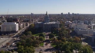 DX0001_001684 - 5.7K aerial stock footage ascend from park for stationary view of the Colorado State Capitol, Downtown Denver, Colorado