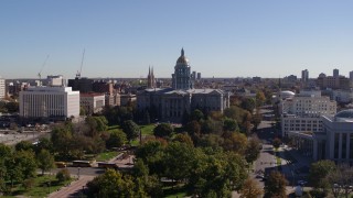DX0001_001689 - 5.7K aerial stock footage of the Colorado State Capitol building, seen while ascending from park, Downtown Denver, Colorado