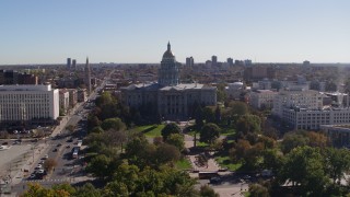 DX0001_001691 - 5.7K aerial stock footage of a view of the Colorado State Capitol building, seen while flying over park, Downtown Denver, Colorado