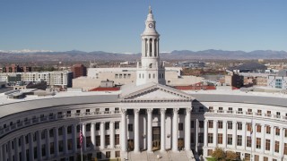 DX0001_001697 - 5.7K aerial stock footage ascend with view of top of the Denver City Council building, Downtown Denver, Colorado