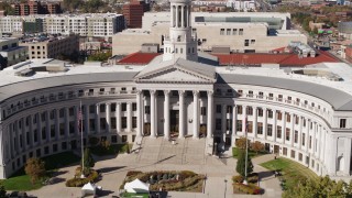 DX0001_001716 - 5.7K aerial stock footage reverse view of the Denver City Council building during ascent, Downtown Denver, Colorado