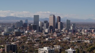 DX0001_001740 - 5.7K aerial stock footage slow descent by the city's skyline with mountains in background, Downtown Denver, Colorado
