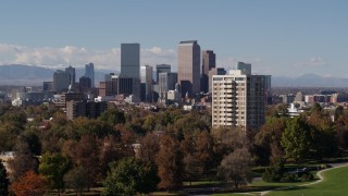 DX0001_001744 - 5.7K aerial stock footage ascend while focusing on the city's skyline with mountains in distance, Downtown Denver, Colorado