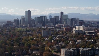 DX0001_001750 - 5.7K aerial stock footage of the city's skyline with Rockies in the background, reveal clock tower, Downtown Denver, Colorado