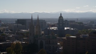 DX0001_001757 - 5.7K aerial stock footage of the Colorado State Capitol seen while passing cathedral, Downtown Denver, Colorado