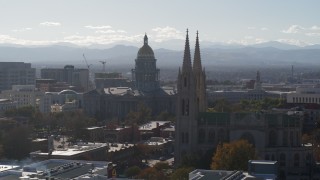 DX0001_001762 - 5.7K aerial stock footage of the Colorado State Capitol and a nearby cathedral, Downtown Denver, Colorado