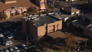 DX0001_001768 - 5.7K aerial stock footage of orbiting a brick police station in Denver, Colorado