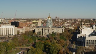 DX0001_001782 - 5.7K aerial stock footage of Colorado State Capitol by tree-lined park in Downtown Denver, Colorado