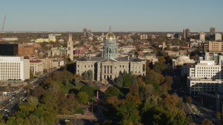 DX0001_001786 - 5.7K aerial stock footage of slow reverse from Colorado State Capitol and tree-lined park in Downtown Denver, Colorado