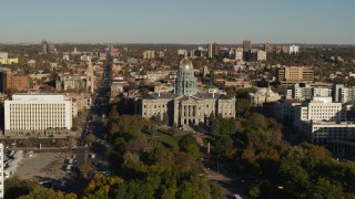 DX0001_001790 - 5.7K aerial stock footage fly away from the Colorado State Capitol and tree-lined park, then descend in Downtown Denver, Colorado