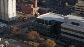 DX0001_001803 - 5.7K aerial stock footage of orbiting the side of a police crime lab and descend in Downtown Denver, Colorado
