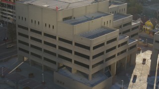 DX0001_001806 - 5.7K aerial stock footage of an orbit of the side of a police station in Downtown Denver, Colorado
