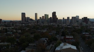 DX0001_001838 - 5.7K aerial stock footage of a reverse view of the city skyline at sunset, Downtown Denver, Colorado