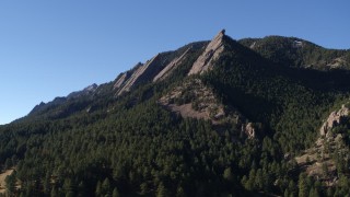 DX0001_001897 - 5.7K aerial stock footage of flying away from and by the flatirons on the side of Green Mountain in the Rocky Mountains, Colorado
