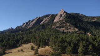 DX0001_001899 - 5.7K aerial stock footage of passing by and fly away from the flatirons on the side of Green Mountain in the Rocky Mountains, Colorado