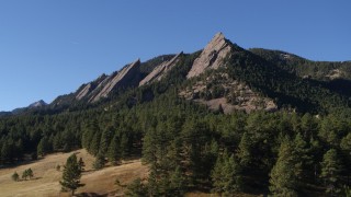 DX0001_001902 - 5.7K aerial stock footage of flying by trees and Green Mountain's flatirons in the Rocky Mountains, Colorado