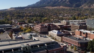DX0001_001906 - 5.7K aerial stock footage of a brick office building at quiet intersection seen while descending in Boulder, Colorado