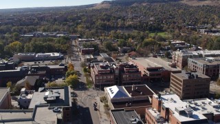 DX0001_001907 - 5.7K aerial stock footage ascend and flyby a brick office building at quiet intersection in Boulder, Colorado
